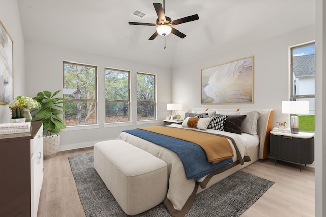 bedroom featuring lofted ceiling, ceiling fan, and light wood-type flooring