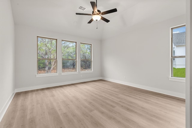 empty room featuring vaulted ceiling, ceiling fan, and light hardwood / wood-style flooring