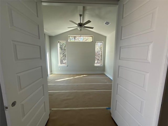 interior space with carpet floors, ceiling fan, and lofted ceiling