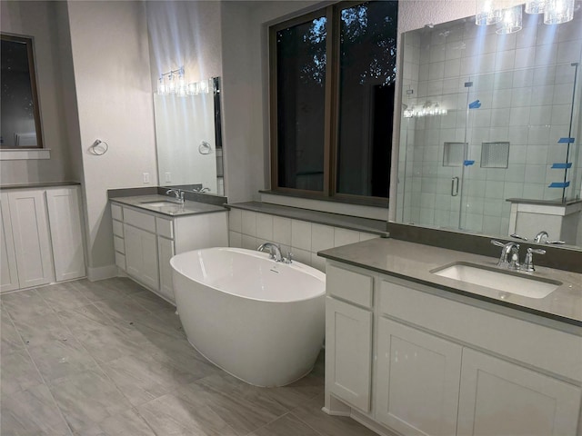 bathroom featuring a shower with door, vanity, and tile patterned flooring