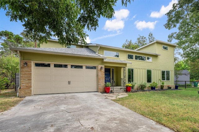 view of front of house with a garage and a front yard