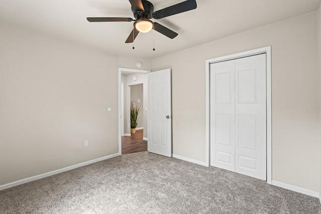 unfurnished bedroom with carpet, ceiling fan, and a closet