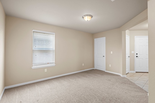 unfurnished room with light colored carpet