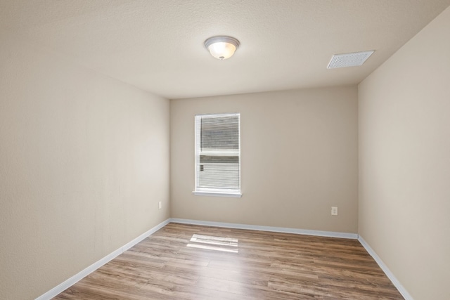 unfurnished room featuring hardwood / wood-style floors