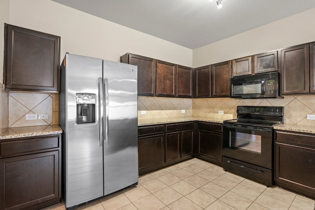 kitchen featuring dark brown cabinets, light stone counters, light tile patterned flooring, tasteful backsplash, and black appliances