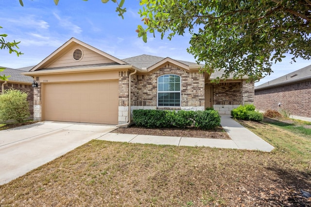 ranch-style home with a front lawn and a garage