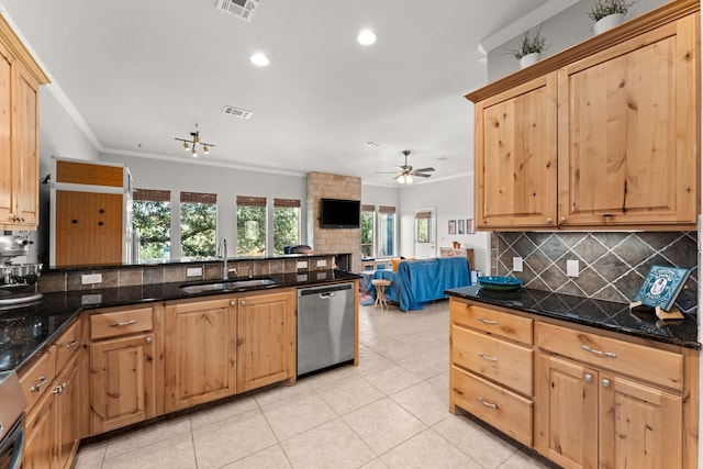 kitchen featuring ceiling fan, dishwasher, dark stone counters, crown molding, and sink