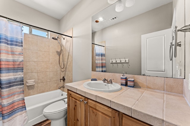 full bathroom with toilet, vanity, and shower / bath combo