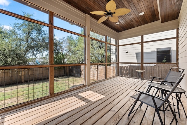 unfurnished sunroom with ceiling fan