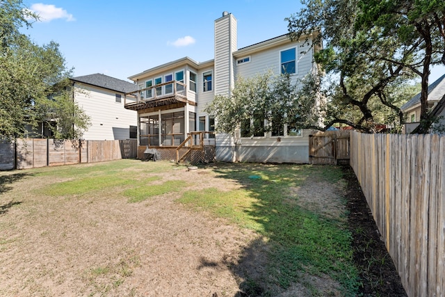 rear view of property with a lawn and a balcony