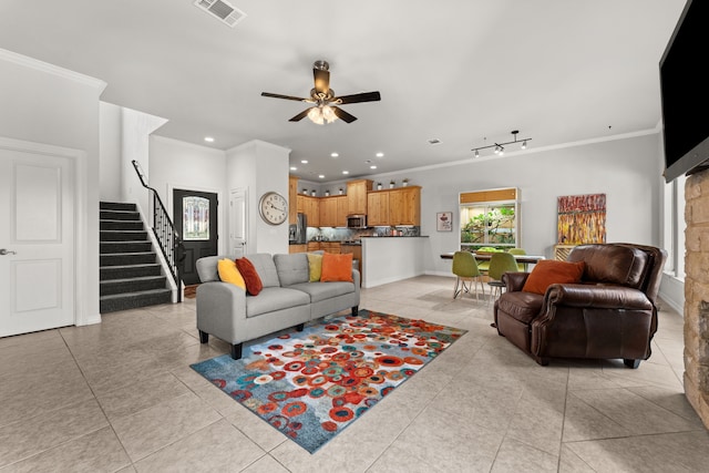 tiled living room featuring ceiling fan, rail lighting, and crown molding