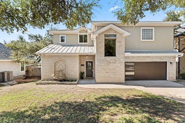 view of front of house with central AC, driveway, a garage, metal roof, and a standing seam roof