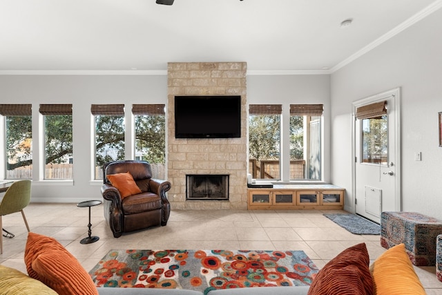 living room with a fireplace, baseboards, tile patterned flooring, ceiling fan, and ornamental molding