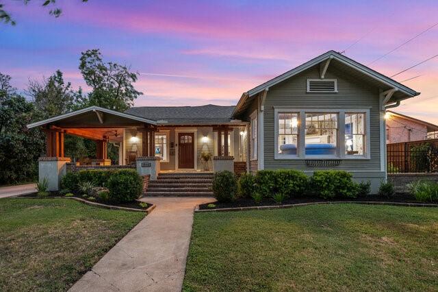 view of front of house with a yard and a porch