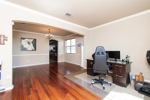 office area with wood-type flooring, ornamental molding, and a notable chandelier