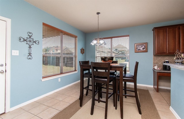 dining room with a notable chandelier and light tile patterned flooring