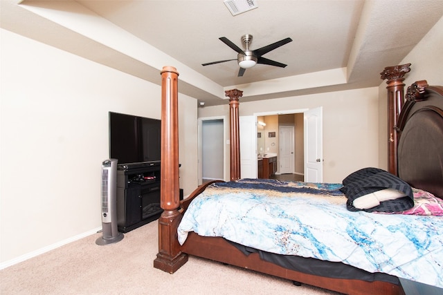 bedroom featuring ceiling fan, light colored carpet, and ensuite bathroom