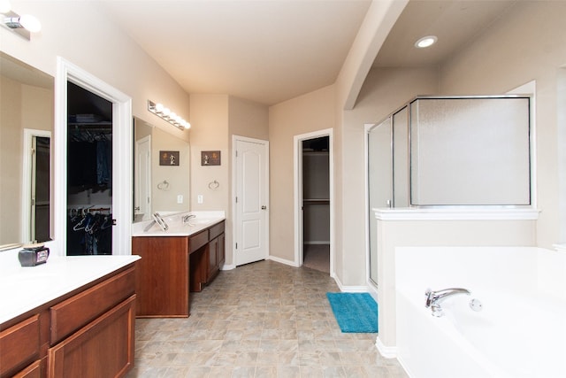 bathroom featuring vanity and shower with separate bathtub