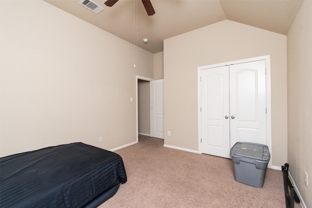 bedroom with light carpet, a closet, lofted ceiling, and ceiling fan