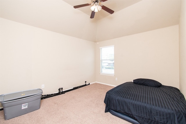 carpeted bedroom with ceiling fan and high vaulted ceiling