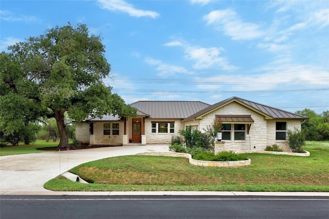 1323 Hi Cir N, Horseshoe Bay, TX 78657 - view of front facade with stone siding, a standing seam roof, curved driveway, and a front lawn