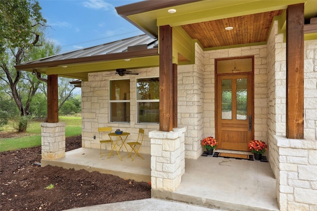 1323 Hi Cir N, Horseshoe Bay, TX 78657 - entrance to property with ceiling fan, a porch, stone siding, a standing seam roof, and metal roof