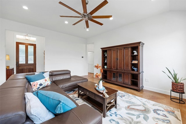 living room with light hardwood / wood-style floors, lofted ceiling, and ceiling fan