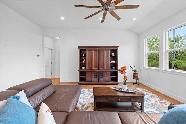 living room with lofted ceiling, ceiling fan, and hardwood / wood-style flooring