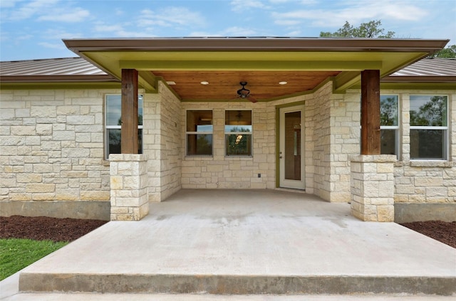 1323 Hi Cir N, Horseshoe Bay, TX 78657 - view of exterior entry with ceiling fan, metal roof, and stone siding