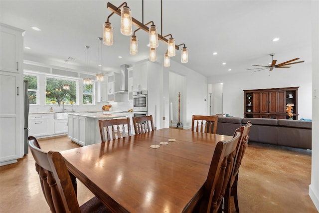 dining area with ceiling fan and sink