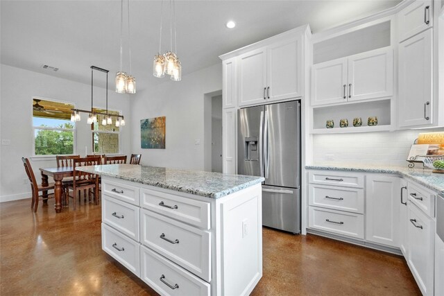 1323 Hi Cir N, Horseshoe Bay, TX 78657 - kitchen featuring stainless steel fridge with ice dispenser, concrete floors, a chandelier, open shelves, and backsplash