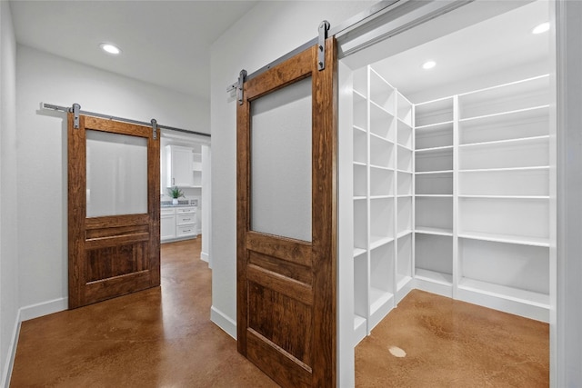 1323 Hi Cir N, Horseshoe Bay, TX 78657 - hallway featuring a barn door, concrete floors, and recessed lighting