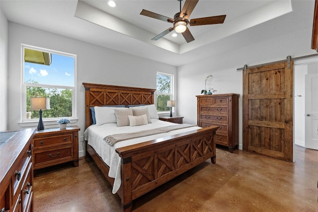 1323 Hi Cir N, Horseshoe Bay, TX 78657 - bedroom with concrete flooring, a tray ceiling, recessed lighting, a barn door, and a ceiling fan