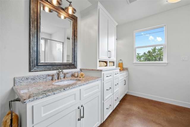 bathroom with concrete flooring, walk in shower, and vanity