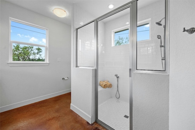 bathroom featuring a wealth of natural light and a shower with door