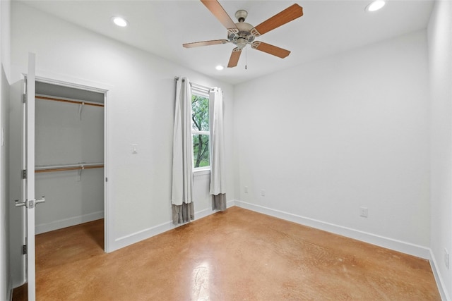 1323 Hi Cir N, Horseshoe Bay, TX 78657 - unfurnished bedroom with recessed lighting, concrete flooring, baseboards, a closet, and a walk in closet
