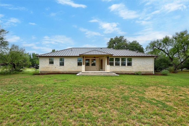 1323 Hi Cir N, Horseshoe Bay, TX 78657 - back of property featuring stone siding, a standing seam roof, a lawn, and metal roof