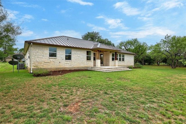 1323 Hi Cir N, Horseshoe Bay, TX 78657 - rear view of house with a standing seam roof, stone siding, a yard, and metal roof