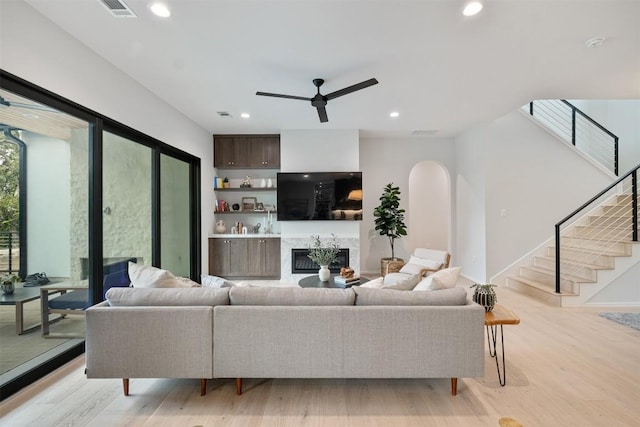 living room featuring ceiling fan and light hardwood / wood-style flooring