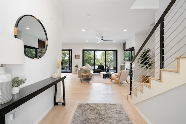 interior space with ceiling fan and light hardwood / wood-style flooring