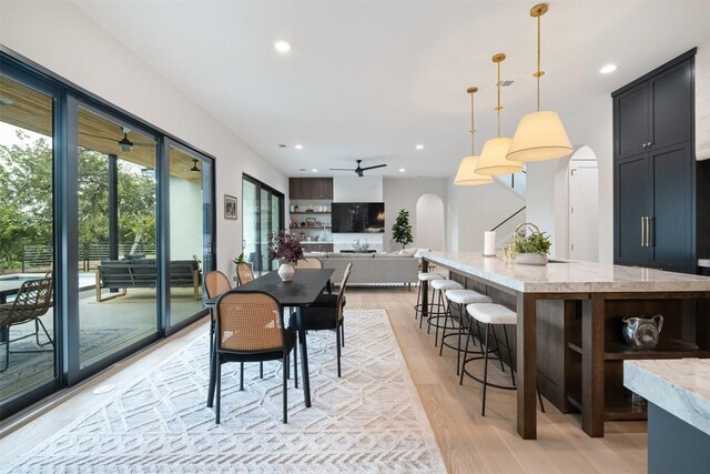 dining space featuring light hardwood / wood-style floors and ceiling fan