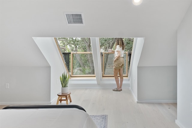 bedroom featuring multiple windows and light hardwood / wood-style floors