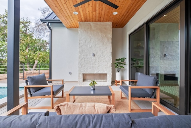 view of patio featuring an outdoor living space with a fireplace and ceiling fan