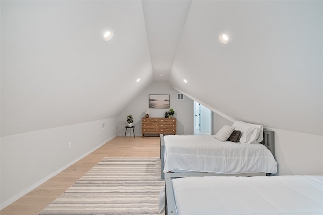 bedroom with light hardwood / wood-style flooring and vaulted ceiling