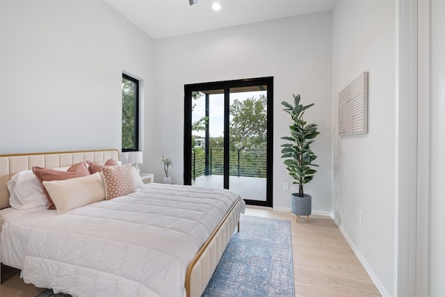 bedroom with access to exterior and light hardwood / wood-style floors