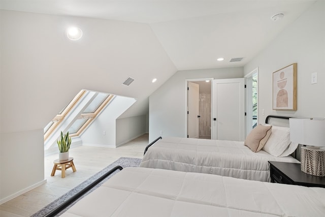 bedroom featuring light hardwood / wood-style flooring and lofted ceiling