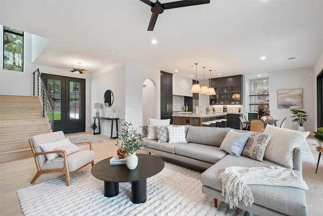 living room featuring light hardwood / wood-style flooring and ceiling fan