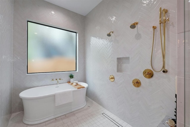 bathroom featuring tile patterned flooring and shower with separate bathtub