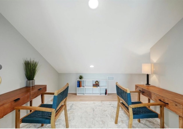 office space featuring light hardwood / wood-style floors and vaulted ceiling