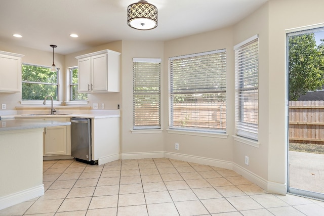 110 Dogwood Dr, Georgetown, TX 78626 - kitchen featuring stainless steel dishwasher, white cabinetry, light countertops, a sink, and hanging light fixtures